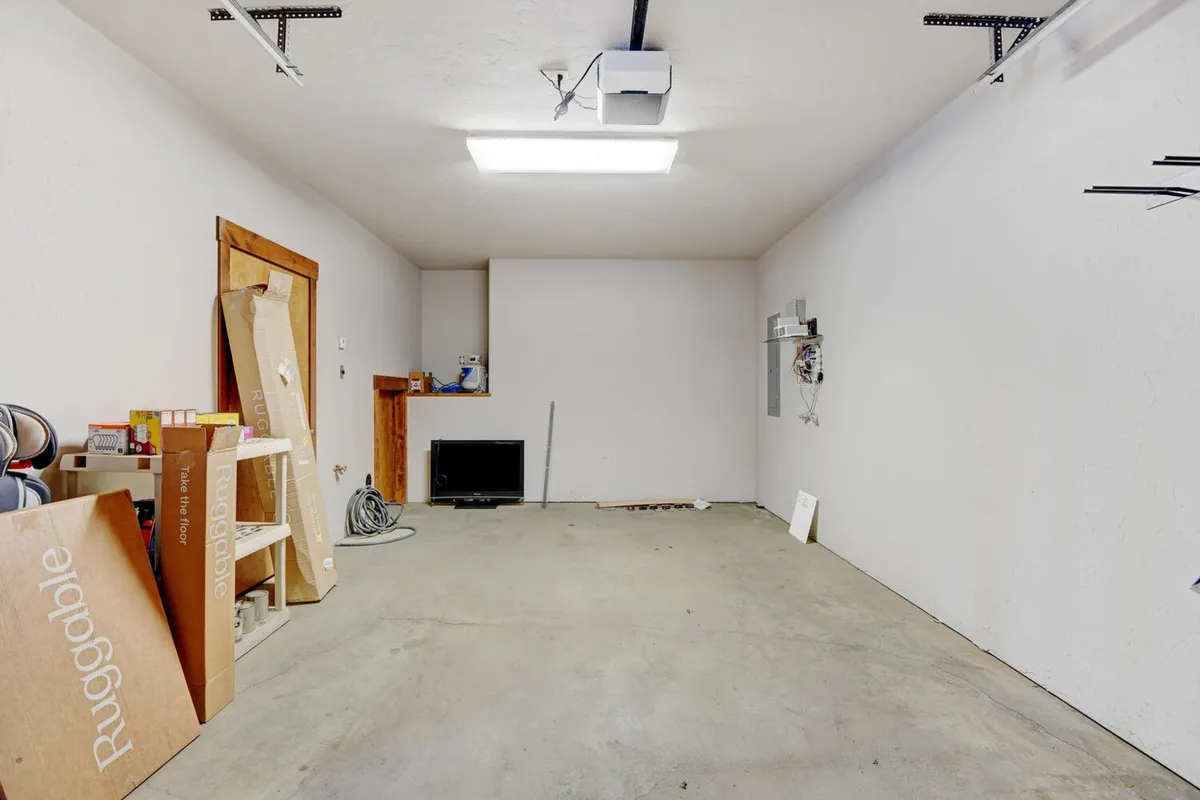 A practical interior space with a storage shelf and ample floor space, likely used as a heated garage. The setting is functional and ready for organizing gear, from skis to bikes, aligning with the section’s emphasis on convenience and tailored amenities for every season.